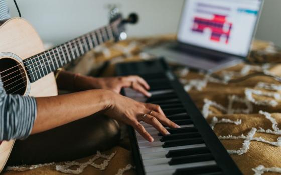 Person with guitar and keyboard