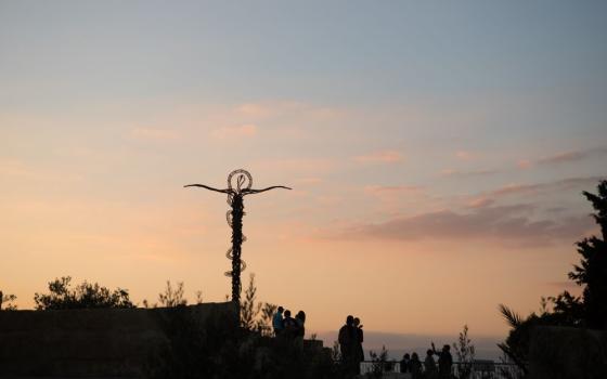 A sculpture representing Moses' staff and the serpent is seen on Mount Nebo Oct. 9, 2017. at sunset in Jordan. Mount Nebo is the place where Moses is said to have seen the Promised Land and died. (CNS/James Ramos, Texas Catholic Herald)