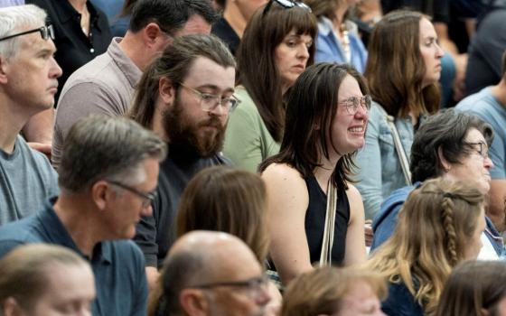 A woman reacts during a prayer vigil at the Academy of Holy Angels following a shooting earlier in the day at Annunciation Church in Minneapolis Aug. 27. The shooter killed two students and injured another 17 people. (OSV News/Reuters/Tim Evans)