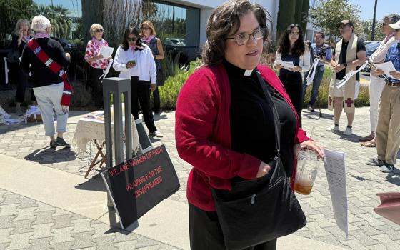 The Rev. Oona Casanova Vazquez, lead pastor of the South Bay Church of the Nazarene in Torrance, stands outside Santa Ana Immigration Court during a prayer vigil for immigrants in Santa Ana, Calif., July 31, 2025. (AP Photo/Deepa Bharath)