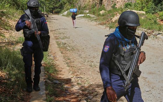 Police officers patrol the area near the Saint-Helene orphanage in the Kenscoff neighborhood of Port-au-Prince, Haiti, Aug. 4, 2025. (AP Photo/Odelyn Joseph)