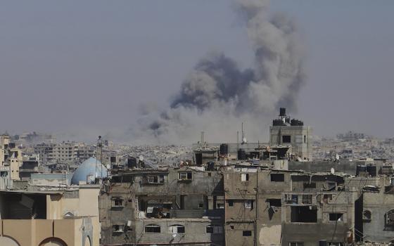 Smoke rises to the sky following an Israeli army airstrike in Khan Younis, in the Gaza Strip, Aug. 18, 2025, the day Fr. Gabriel Romanelli, pastor of Holy Family Church in Gaza, received an evacuation notice by the Israeli Defense Forces. (AP photo/Mariam Dagga)