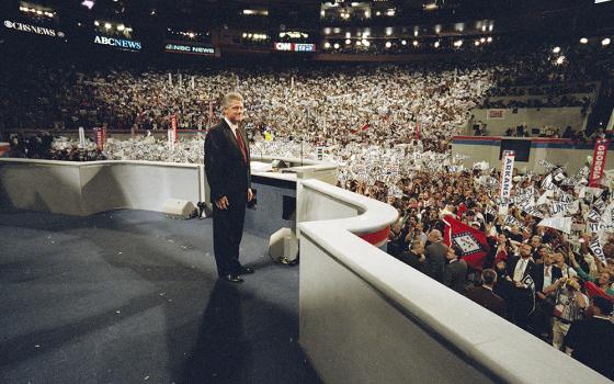 Democratic presidential nominee Bill Clinton faces a cheering audience after taking the podium to deliver his acceptance speech as his party's presidential nominee during the Democratic National Convention at Madison Square Garden in New York, July 16, 1992. (AP Photo/Stephan Savoia, File)