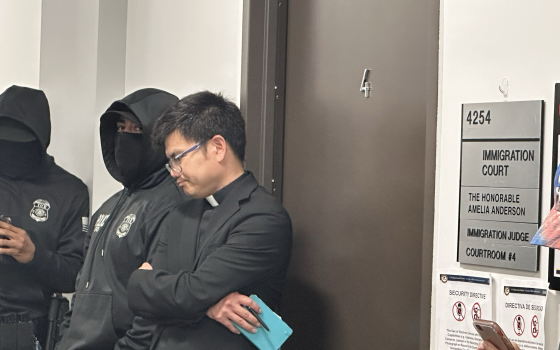 The Rev. Hung Nguyen, SJ, of Our Lady of Guadalupe Church in San Diego waits outside immigration court Aug. 6, 2025, the second day of the San Diego diocese's FAITH ministry. (NCR photo/Chris Stone)