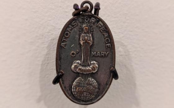 Resembling a Miraculous Medal, this pendant was most likely government propaganda aimed at American Catholics according to an explanatory sign at the "Fallout: Atoms for War & Peace" exhibit. (Mary Ann Cejka)