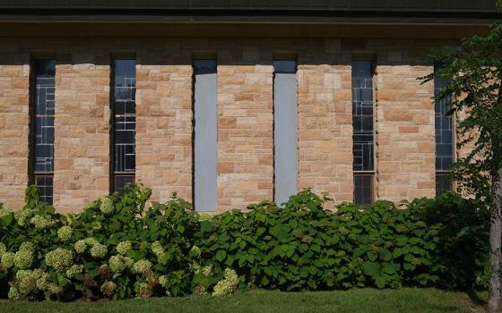 The damaged windows are boarded up at Annunciation Catholic Church after Wednesday's school shooting, Thursday, Aug. 28, 2025, in Minneapolis. (AP photo/Abbie Parr)