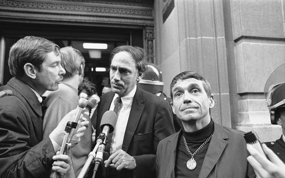 Jesuit Fr. Daniel Berrigan, right, and William Kunstler, defense lawyer, talk with reporters in Baltimore Nov. 9, 1968, after the trial and conviction of the Catonsville Nine. In May that year, Berrigan and eight other Catholics broke into a Selective Service office outside of Baltimore and burned 378 draft files — while reciting the Lord's Prayer — to protest the Vietnam War. (AP/William A. Smith)