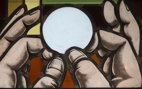 Elevation of the Eucharist is depicted in a stained-glass window at St. Anthony's Church in North Beach, Maryland, July 15, 2021. (CNS/Bob Roller)