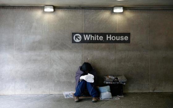 A file photo shows a homeless person trying to stay warm at the entrance of a Metro station near the White House in Washington. (OSV News/Reuters/Kevin Lamarque)