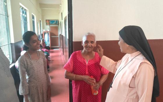 Bethany Sr. Bhagya Thalichirayil interacts with "Didi" (red), a senior resident, and Sujatha (left), the youngest resident of Asha Bhavan, a home for disabled and abandoned women at Ichilampady, a village in Karnataka state, southwestern India. (Thomas Scaria)