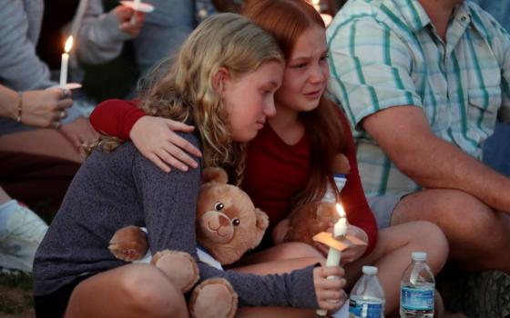 People gather at a vigil at Lynnhurst Park after a fatal shooting at the Annunciation Catholic School, Aug. 27 in Minneapolis. (AP Photo/Bruce Kluckhohn)