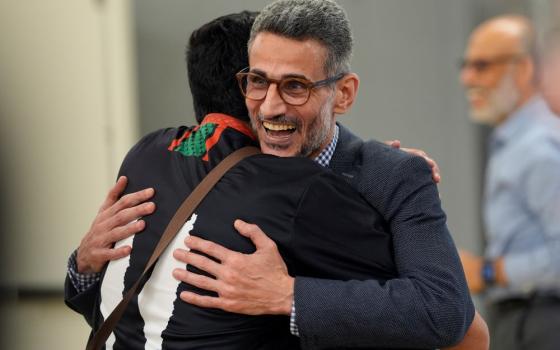 Ayman Soliman is greeted by a supporter as he arrives for a news conference at the Clifton Mosque in Cincinnati Sept. 19 after being released from ICE custody. (AP/Carolyn Kaster)