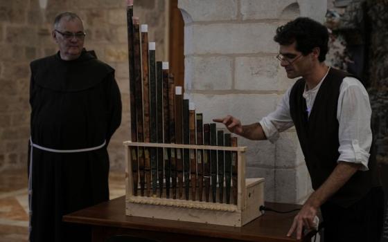 David Catalunya, a Valencian musician and musicologist, displays an 11th-century organ that researchers say is the oldest in the Christian world. It was played for the first time in 800 years after restoration, in St. Savior's Monastery in Jerusalem's Old City  Sept. 9. (AP/Mahmoud Illean)