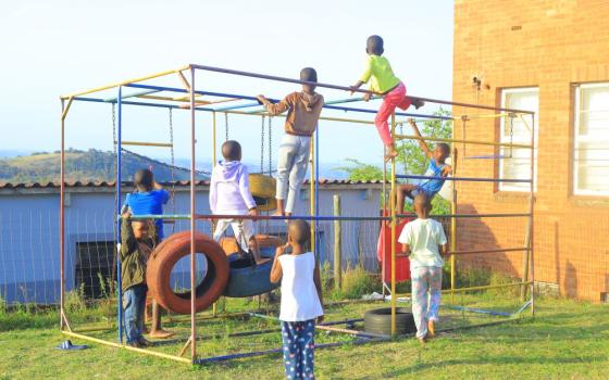 Children play on a worn jungle gym at an outreach center in Durban, South Africa, run by the Daughters of St. Francis of Assisi. (GSR photo/Doreen Ajiambo)