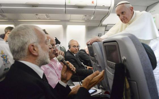 Pope Francis listens to a question from a journalist on his flight heading back to Rome from Brazil July 28, 2013. Francis was making his first trip abroad as pope to join more than 300,000 young people in Brazil for World Youth Day. (CNS/Pool via Reuters)