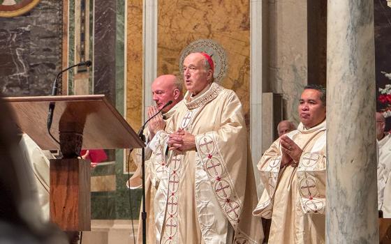 Cardinal Robert McElroy leads prayer Sept. 28, 2025, at the Cathedral of St. Matthew the Apostle in Washington during a Mass for World Day of Migrants and Refugees, which the church observes Oct. 4-5 this year. In his homily, McElroy, archbishop of Washington, singled out what he called the government's assaults against migrants and thanked church members and others who have come to their aid. (GSR photo/Rhina Guidos)