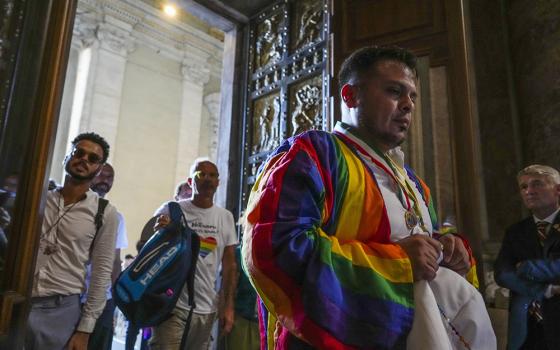 Some of the hundreds of LGBTQ+ Catholics and their families who joined a Holy Year pilgrimage to Rome, celebrating a new level of acceptance in the Catholic Church and crediting Pope Francis for the change, walk through the Holy Door of St. Peter's Basilica at the Vatican, Saturday, Sept. 6, 2025. (AP photo/Andrew Medichini)