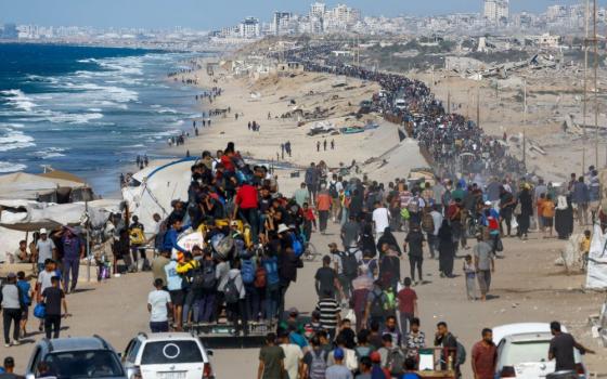 Palestinians, who were displaced to the southern part of Gaza at Israel's order during the war, make their way along a road in the central Gaza Strip as they return to the north Oct. 10 after a ceasefire between Israel and Hamas in Gaza went into effect. (OSV News/Reuters/Mahmoud Issa)