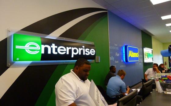 Staff work at a car rental counter for companies including Enterprise and Alamo. (Wikimedia Commons/CC Attribution 2.0 Generic/Rusty Clark)