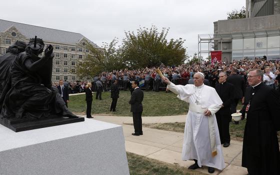 Pope Francis blesses a sculpture during a brief stop at St. Joseph's University in Philadelphia Sept. 27, 2015. The sculpture commemorates the 50th anniversary of "Nostra Aetate," the Second Vatican Council Declaration on the Relationship of the Church to Non-Christian Religions. (CNS photo/Paul Haring)