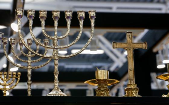 A menorah and crucifix are seen side by side at the International Religious Products and Services Exhibition in Bologna, Italy, Feb. 13, 2024. (CNS/Justin McLellan)