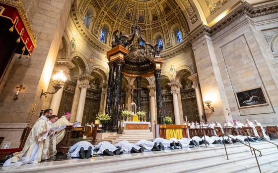 Thirteen men being ordained to the priesthood during a May 25, 2024, Mass at the Cathedral of St. Paul in St. Paul, Minn., lie prostrate during the litany of saints. (OSV News file/The Catholic Spirit/Dave Hrbacek)