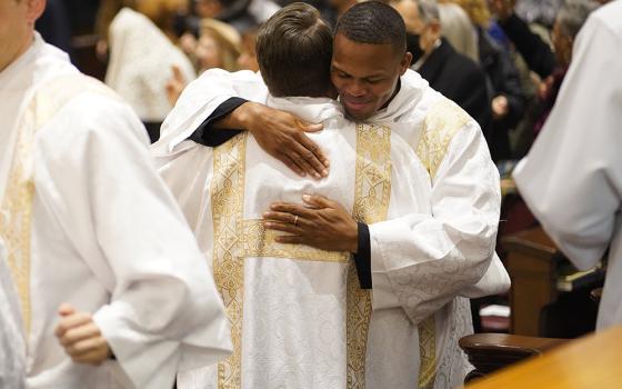 Callistus Ibeh, right, exchanges the sign of peace with fellow Diocese of Brooklyn, New York, seminarian Juan Herrera-Posada during their ordination to the transitional diaconate at St. Joseph's Seminary in Yonkers, New York., Nov. 9, 2024. (OSV News/Gregory A. Shemitz)