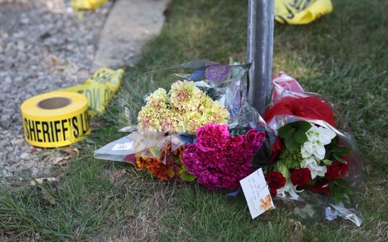 Flowers are left at a police blockade near the Church of Jesus Christ of Latter-day Saints, Monday, Sept. 29, 2025 in Grand Blanc Township, Mich. (AP/Carlos Osorio)