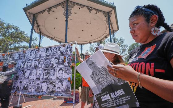 Activist and farm worker Xochitl Nunez, right, holds up a picture of late farm worker Jaime Alanis, believed to be the first fatality during an ICE immigration raid, as she joins farmworkers, immigrant leaders, labor allies, and organizers to announce a national "Farmworker Strike for Dignity" during a news conference at La Placita Olvera in Los Angeles, July 14, 2025. (AP photo/Damian Dovarganes)