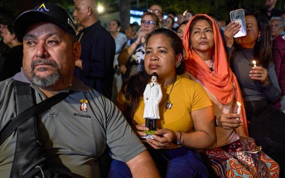 Believers watch the canonization ceremony of José Gregorio Hernández and Mother Carmen Rendiles Martínez by Pope Leo XIV during an event to celebrate Venezuela's first saints at a square in Caracas, Venezuela, Oct. 19, 2025. (AP/Ariana Cubillos)