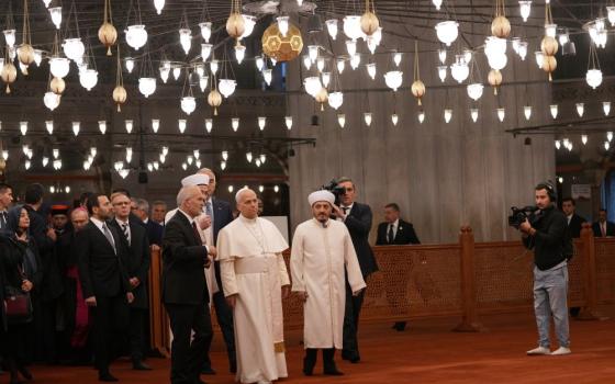 Pope Leo XIV, center, walking with Muezzin Musa Asgın Tunca, left, Dr. Emrullah Tuncel, second from left, and Imam of Mosque Sultanahmet Fatih Kaya, visits the Sultan Ahmed Mosque in Istanbul Nov. 29. 