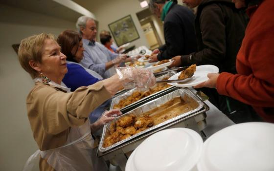 Volunteers are pictured in a file photo serving people in need during a free dinner provided by the Emergency Assistance Department of Chicago Catholic Charities. (OSV News/Jim Young, Reuters)
