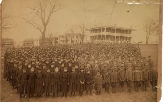 This photo shows the 1892 student body of the Carlisle Indian Industrial School assembled on the school grounds in Carlisle, Pa.