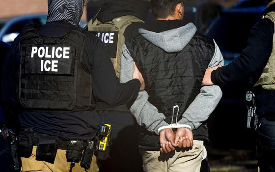 Agents with the Immigration and Customs Enforcement detain a man after conducting a raid at the Cedar Run apartment complex in Denver Feb. 5, 2025. (OSV News photo/Reuters/Kevin Mohatt)