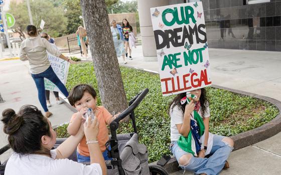 Brendaletzy Lopez, 30, a recipient of the Deferred Action for Childhood Arrivals policy, holds a placard that reads, "Our dreams are not illegal," ahead of a hearing on the DACA program, outside the federal courthouse in Houston June 1, 2023. Texas Catholic bishops say a federal court is poised to change the lawful presence of an estimated 90,000 DACA recipients in Texas to unlawful. (OSV News/Reuters/Adrees Latif)
