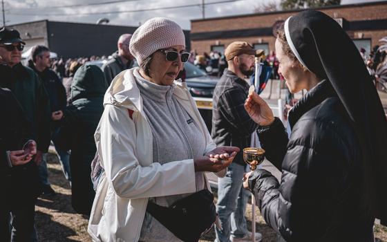 Catholics receive Communion outside the ICE Broadview facility during an outdoor Mass, in Broadview, Illinois, outside Chicago Nov. 1. (Courtesy of Coalition for Spiritual and Public Leadership)
