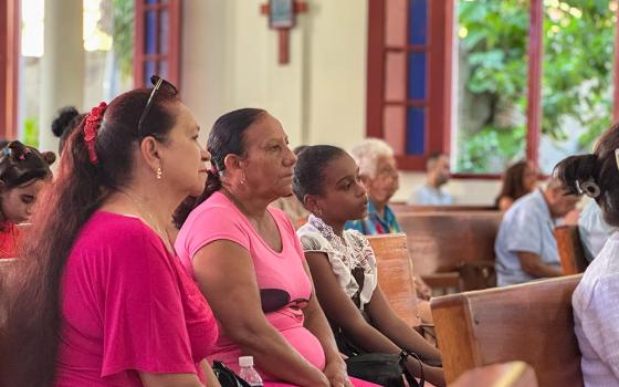 Churchgoers at Our Lady of Mount Carmel in Cueto, in eastern Cuba, listen during Sunday Mass Nov. 16, 2025. The church normally fills up, parishioners said, but many members were absent as they’ve fallen ill to mosquito-transmitted viruses. (NCR photo/Rhina Guidos)
