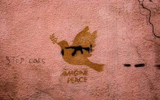Drawing of peace dove on wall, with phrase, "imagine peace"