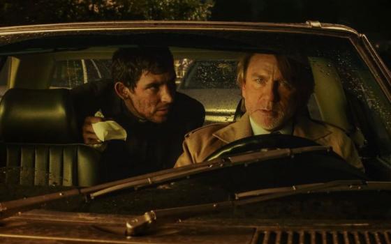 The characters Fr. Jud Duplencity (Josh O'Connor) and Benoit Blanc (Daniel Craig)  "are very much on opposite sides of the [faith] fence, but they've learned from each other," says Rian Johnson, writer and director of "Wake Up Dead Man: A Knives Out Mystery." (Netflix)