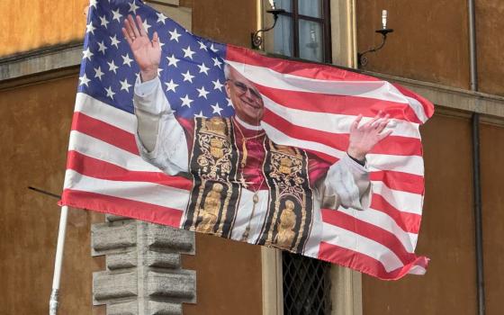 A U.S. flag with a photo of Pope Leo XIV is seen on the Via della Conciliazione near the Vatican June 17.