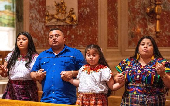 A family prays during Mass at the Cathedral of St. Matthew the Apostle in Washington Sept. 24, 2023. (OSV News/Catholic Standard/Mihoko Owada)