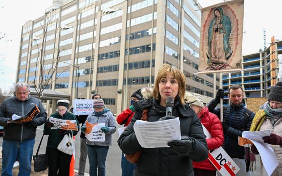 Michele Dunne, a secular Franciscan who is executive director of the Franciscan Action Network, speaks during a prayer vigil outside the U.S. Customs and Immigration Enforcement headquarters in Washington Dec. 12, 2025. (OSV News/Leslie E. Kossoff)