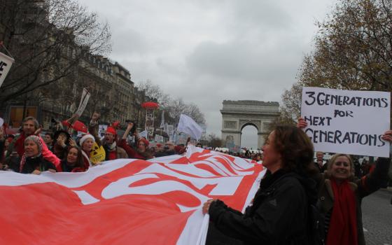 Thousands assembled along the Avenue de la Grande Armee in Paris Dec. 12 hours before 195 nations adopted the Paris Agreement, which provided a framework for global action on climate change. (NCR photos/Brian Roewe)
