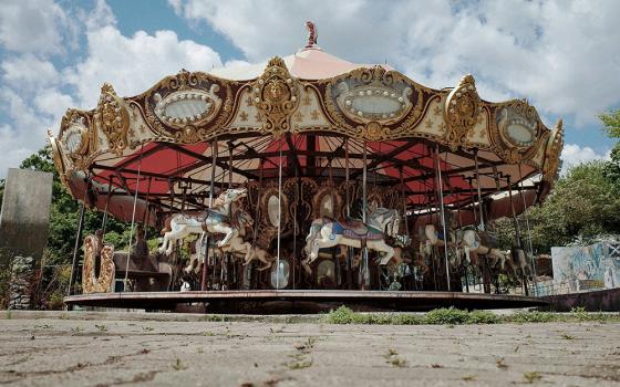 A merry-go-round in a parking lot (Unsplash/Yewon Ahn)