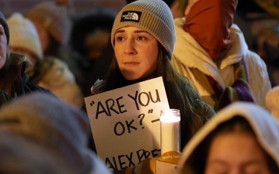 Attendees gather during a vigil where Alex Pretti was shot and killed Jan. 24 by federal officers in Minneapolis on Jan. 28, 2026. Renee Good was shot and killed by ICE agents Jan. 7. (AP/Adam Gray)