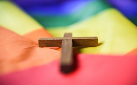 A wooden cross lies on a rainbow flag in Bonn, Germany, March 16, 2021. (OSV News/KNA/Julia Steinbrecht)