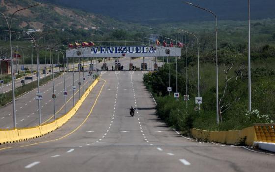 People ride a motorbike along an empty road at the Tienditas Bridge border between Venezuela and Colombia, in Cucuta, Colombia, Jan. 4, following U.S. strikes on Venezuela where President Nicolas Maduro and his wife, Cilia Flores, were captured the previous day. (OSV News/Reuters/Luisa Gonzalez)