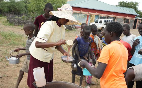 Sr. Jannifer Hiuhu serves porridge to children outside the Incarnate Word Sisters’ convent in northern Kenya. For many students at the congregation’s primary school, the sisters’ "Porridge for Breakfast" program provides their only meal of the day, as nomadic families search for pasture amid a prolonged drought. (GSR photo/Wycliff Peter Oundo)