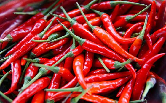 Closeup of a pile of red chili peppers (Unsplash/Elle Hughes)