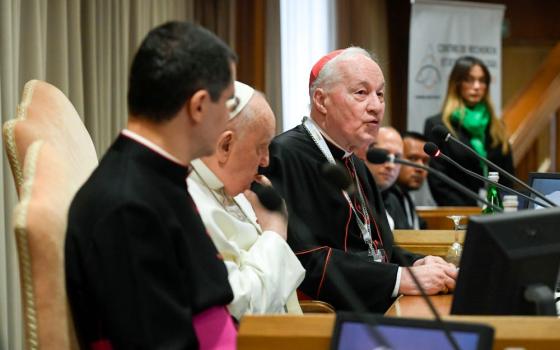 Seated next to Pope Francis, Cardinal Marc Ouellet, president of the Center for Research and Anthropology of Vocations and retired prefect of the Dicastery for Bishops, speaks at an event in the Synod Hall at the Vatican March 1, 2024. (CNS/Vatican Media)